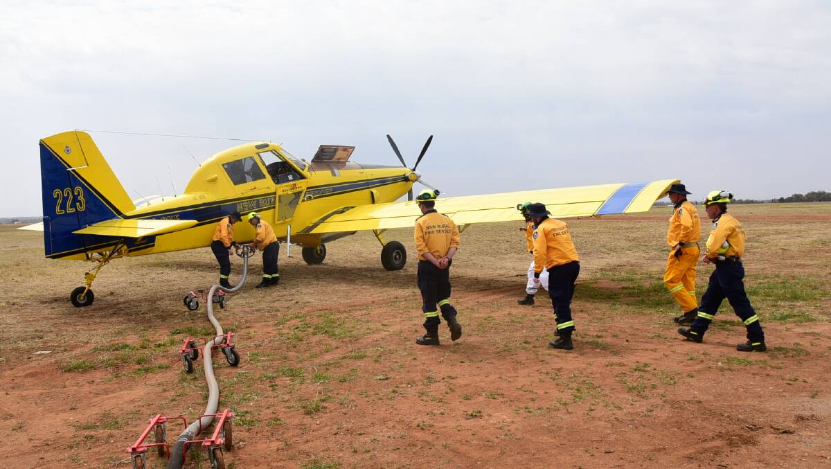 LEARNING: Rural Fire Service volunteers go through the paces at aircraft loading training on Saturday. Photo: PAIGE WILLIAMS