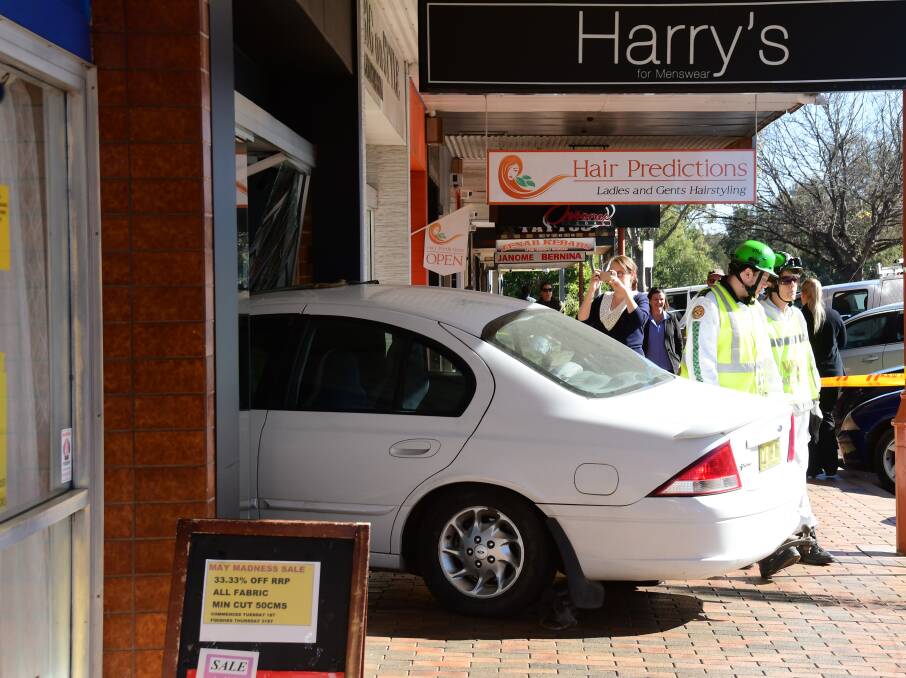 A car was lodged well inside the Harry's For Menswear building on Friday afternoon. Photo: AMY McINTYRE
