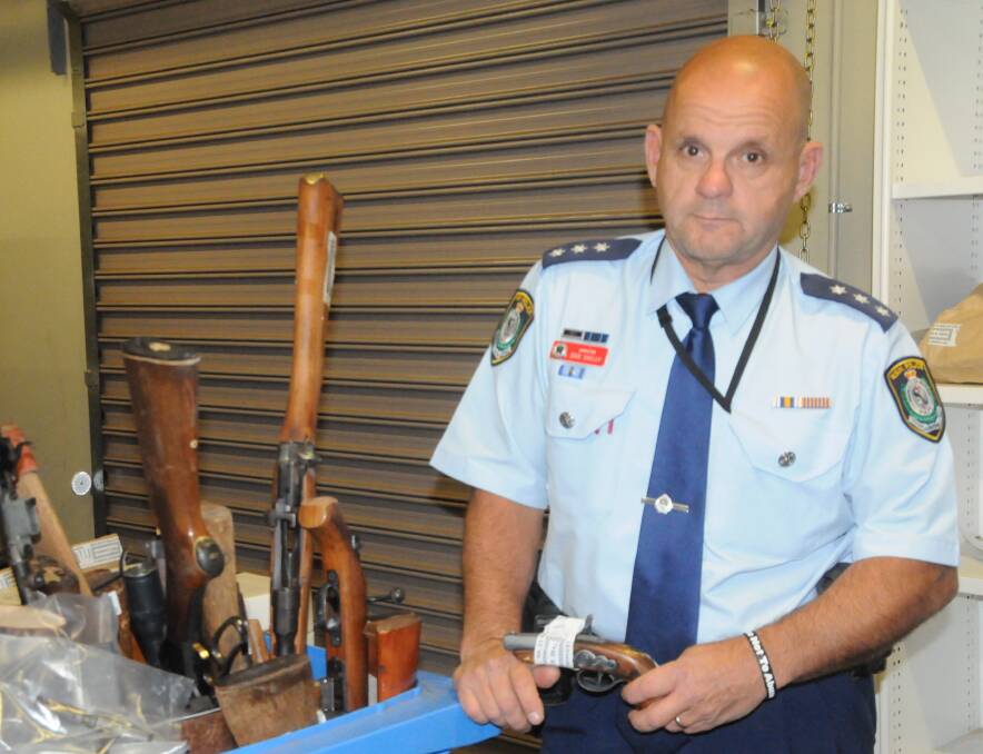 HANDED IN: Inspector Dan Skelly from Orana Local Area Command with some of the weapons surrendered to Dubbo Police Station. Photo: BEN WALKER
