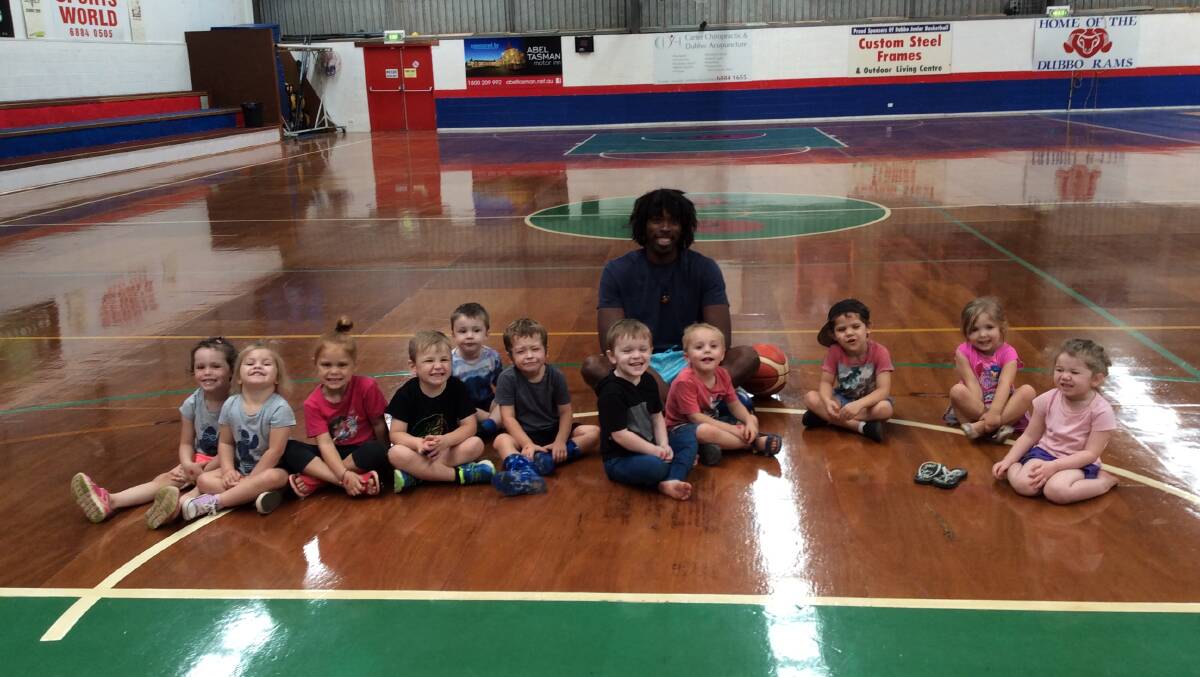 CLINIC: Rams import Adam Ward with some kids from Peppercorn Childcare Centre.