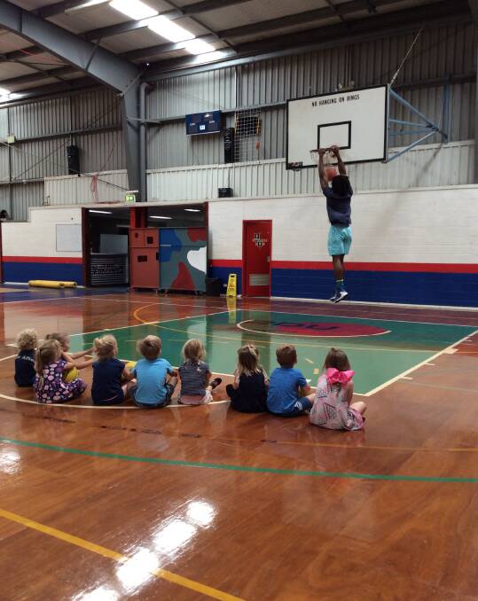 BIG AIR: Star American import Adam Ward shows off his dunking ability to pre-schoolers on Wednesday.