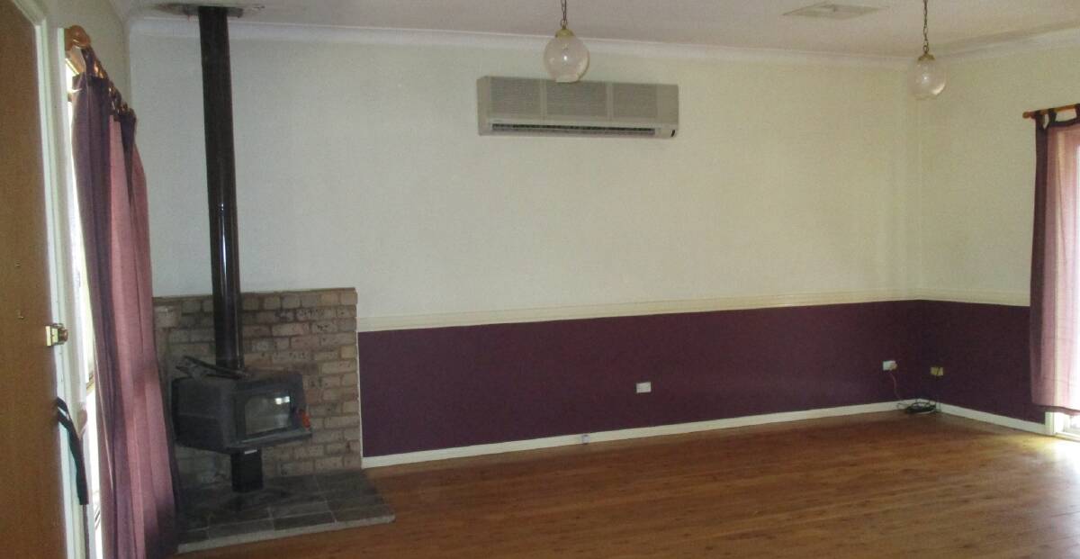 EVERYTHING COVERED: A fireplace and evaporative cooler feature in the living room.