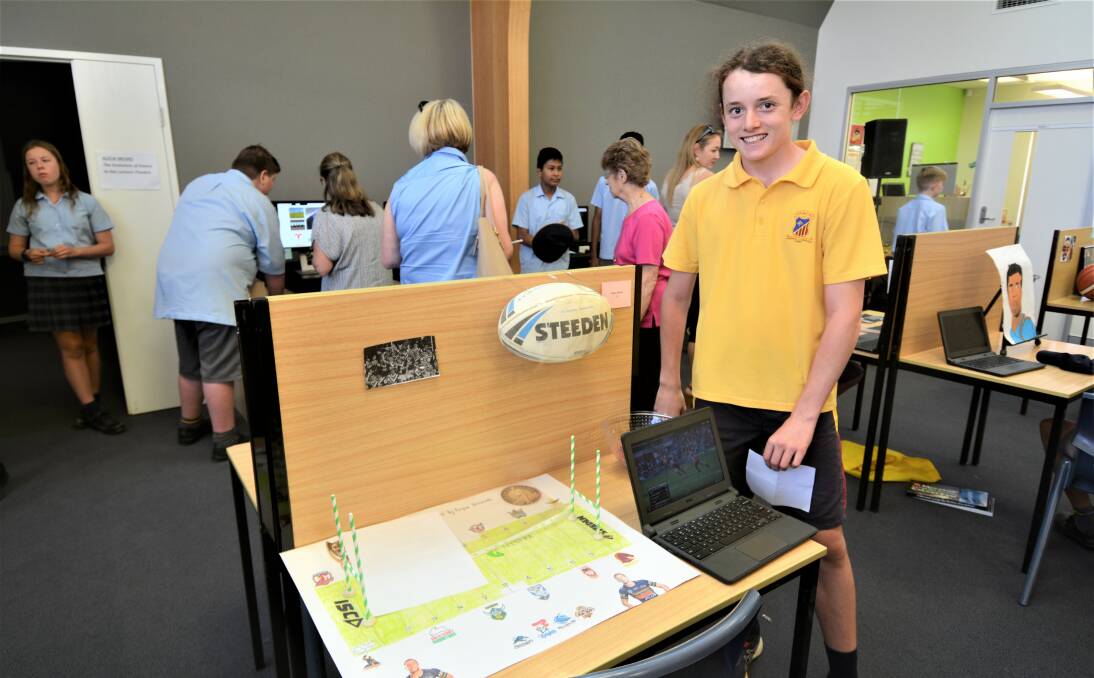 HISTORY OF FOOTY: St John's College year seven student Angus Boland was happy with his project. Photo: TAYLOR DODGE. 