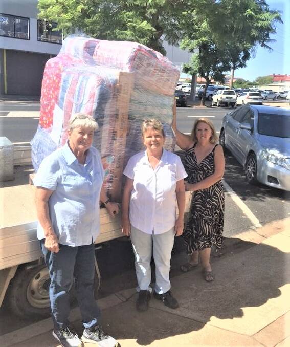 KINDNESS IS KEY: Emmanuel Care- a few of the many volunteers Di Baker, Lorraine Mulholland and Lyn Berge prepare bale for Alice Springs. Photo: CONTRIBUTED.