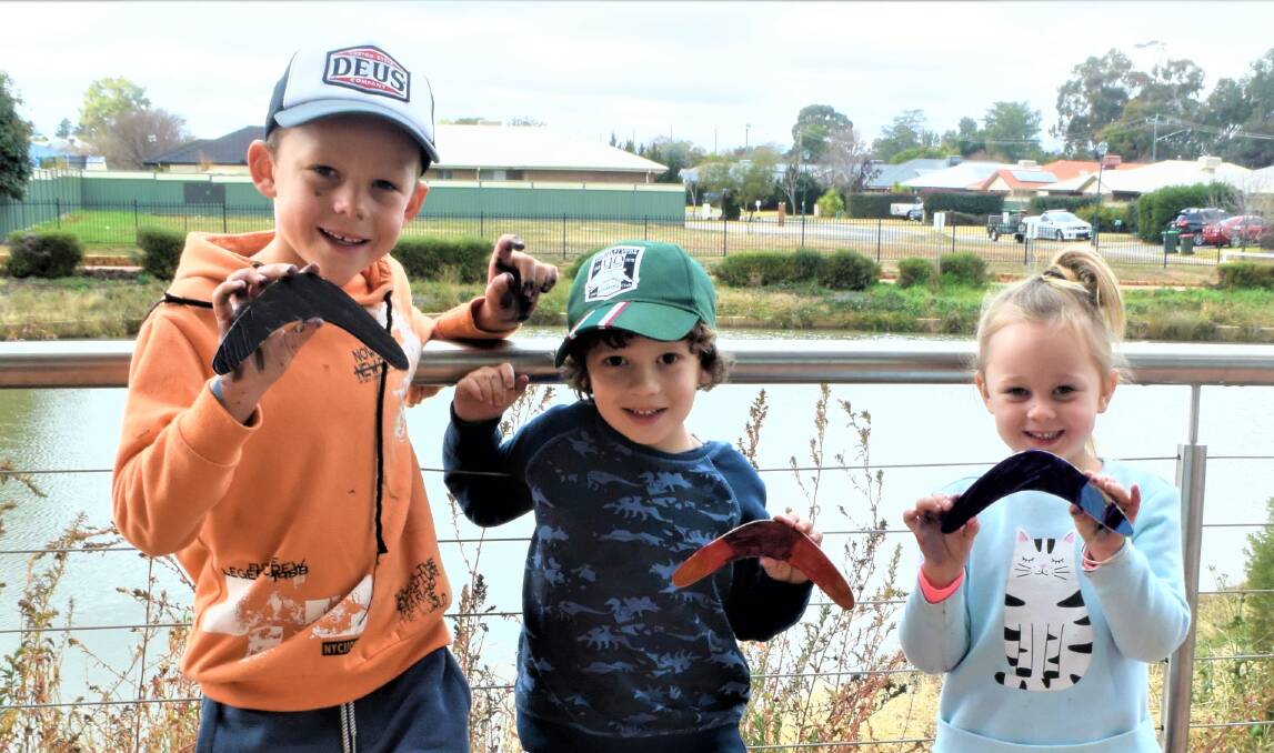 SMILES: Ayden Powyer, Nathaniel Naden and Jordana Powyer revealing their finnised boomerangers. Photo: TAYLOR DODGE.