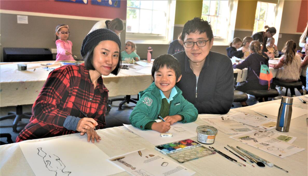 FAMILY FUN: April, Noah and Kay An drawing at a Western Plains Cultural Centre Holiday Workshop 2019. Photo: TAYLOR DODGE.