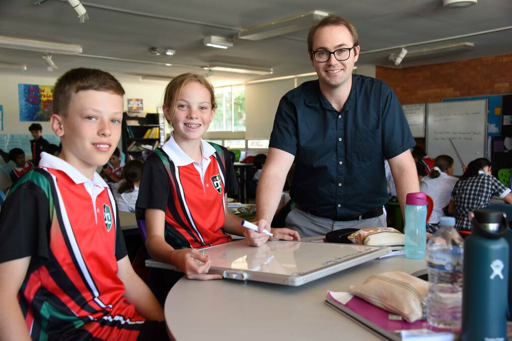 SMILES ALL ROUND: Year 7 Students Evan Nave and Amy Quilty with Mr Aaron Taylor. Photo: CONTRIBUTED. 