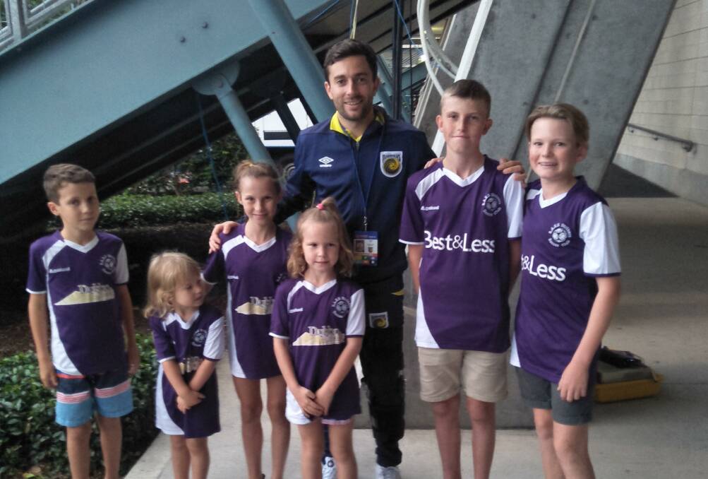 SPECIAL MOMENT: SASS Strikers players with Socceroo player Tommy Oar. Photo: CONTRIBUTED