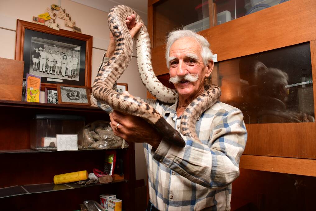 LOVE OF SNAKES: Snake handler Paul Kirk with one of his Pythons. Photo: BELINDA SOOLE. 