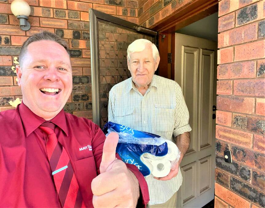 COMMUNITY CARE: Matt Hansen makes a special toilet paper delivery to Alkin Bartlett. Photo: CONTRIBUTED.