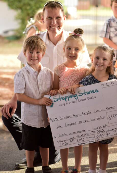 YOUNGLINGS STEPPING UP: Salvation Army Orana captain David Sutcliffe accepting a cheque from North Dubbo Stepping Stones Early Learning Centre children. Photo: SUPPLIED. 
