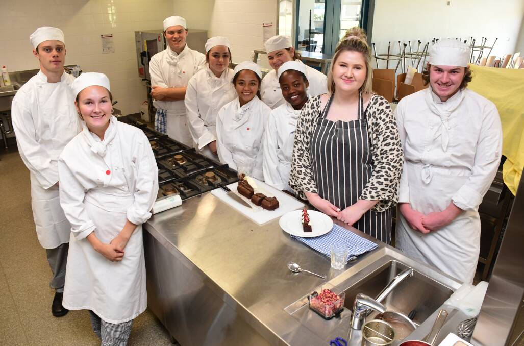 BROWNIE TIME: Caitlyn Amor with St John's College year 12 hospitality students. Photo: AMY McINTYRE. 