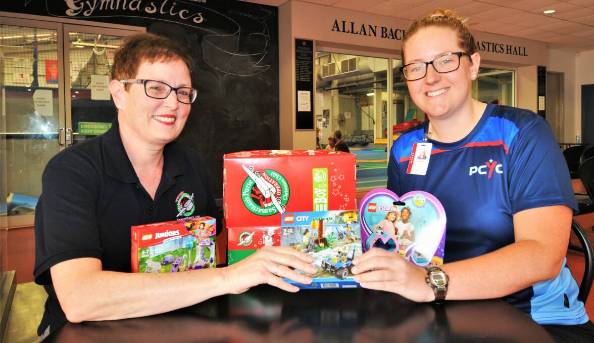 EXCHANGE: Operation Christmas Child area coordinator Sylvia Paice with PCYC Dubbo manager Emily Ross. Photo: TAYLOR DODGE. 