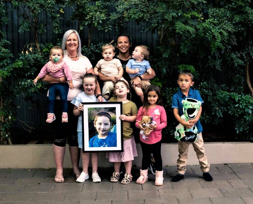 A TEAM EFFORT: Westmead nurses Tanya and Nikki Quinn with survivors and siblings Grace and Hollie Sarpe, Hannah and Connor Ray with a picture of Mitchell Ray and Durakai, Kalyra and Keirajarli Smith. Photo: CONTRIBUTED. 