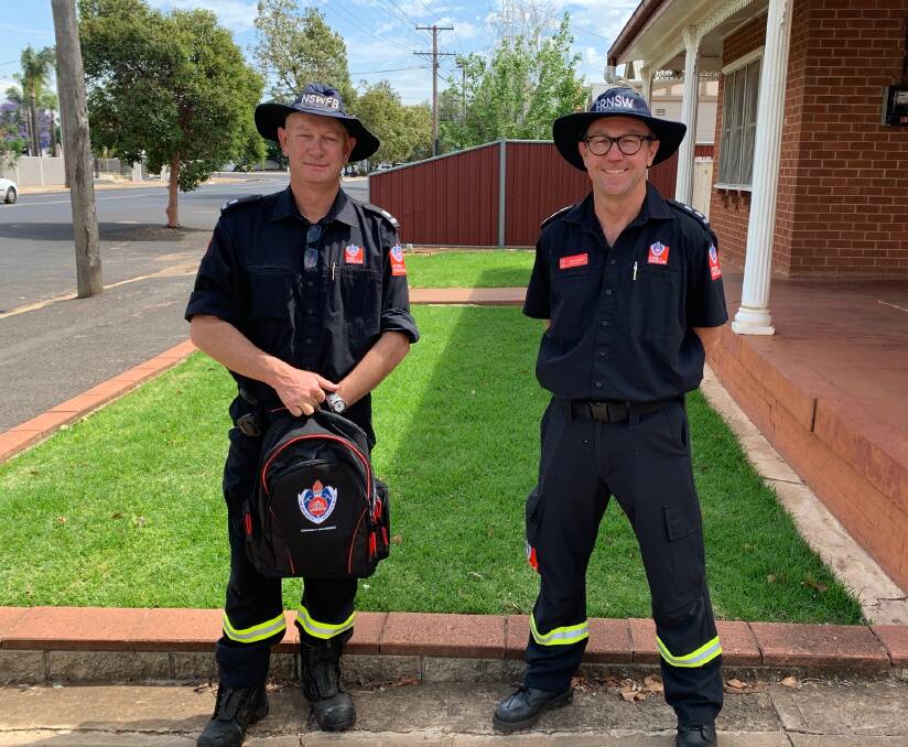 FIRE SAFETY: Leading Firefighter Steve Gilbert and Station Commander Chris Cusack conducting Safety Checks following last months Brisbane St Fire. Photo: CONTRIBUTED. 