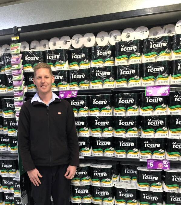 PLENTY ON SHELVES: Dubbo Ashcrofts IGA store manager Pat O'Neill with a shelf full of toilet paper. Photo: TAYLOR DODGE. 