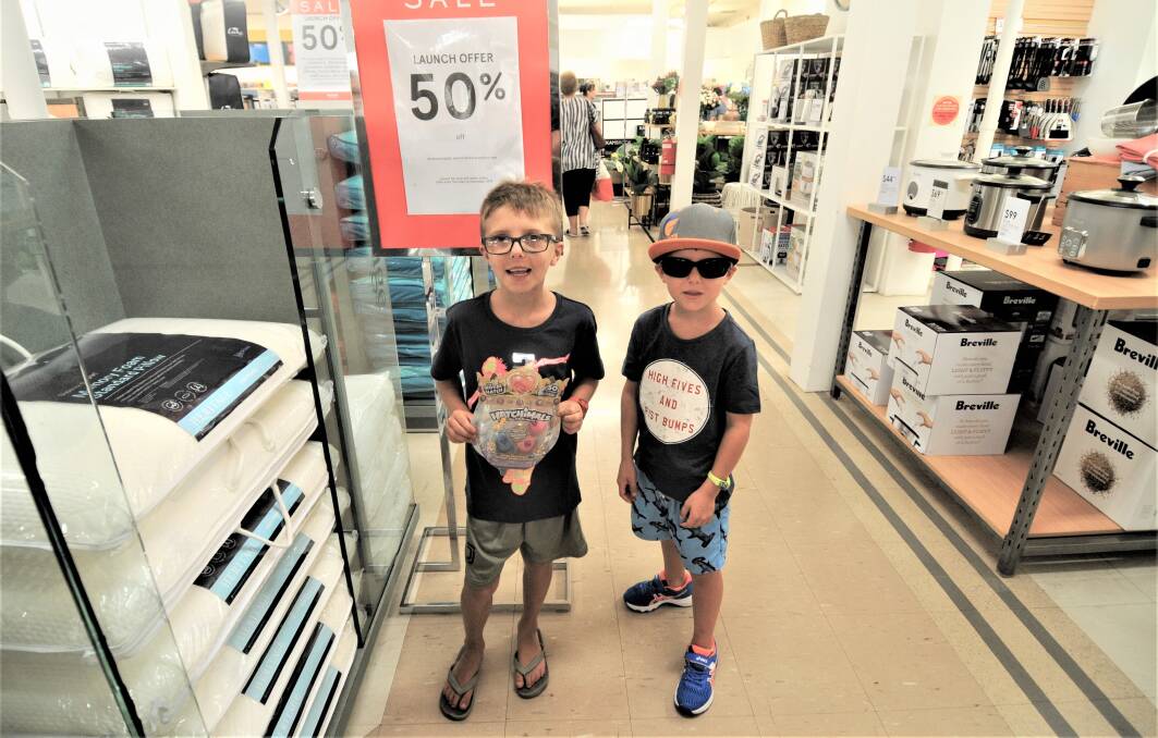 SALES GALORE: Dubbo residents William and Jacob Hudson checking out the Boxing Day sales. Photo: TAYLOR DODGE. 