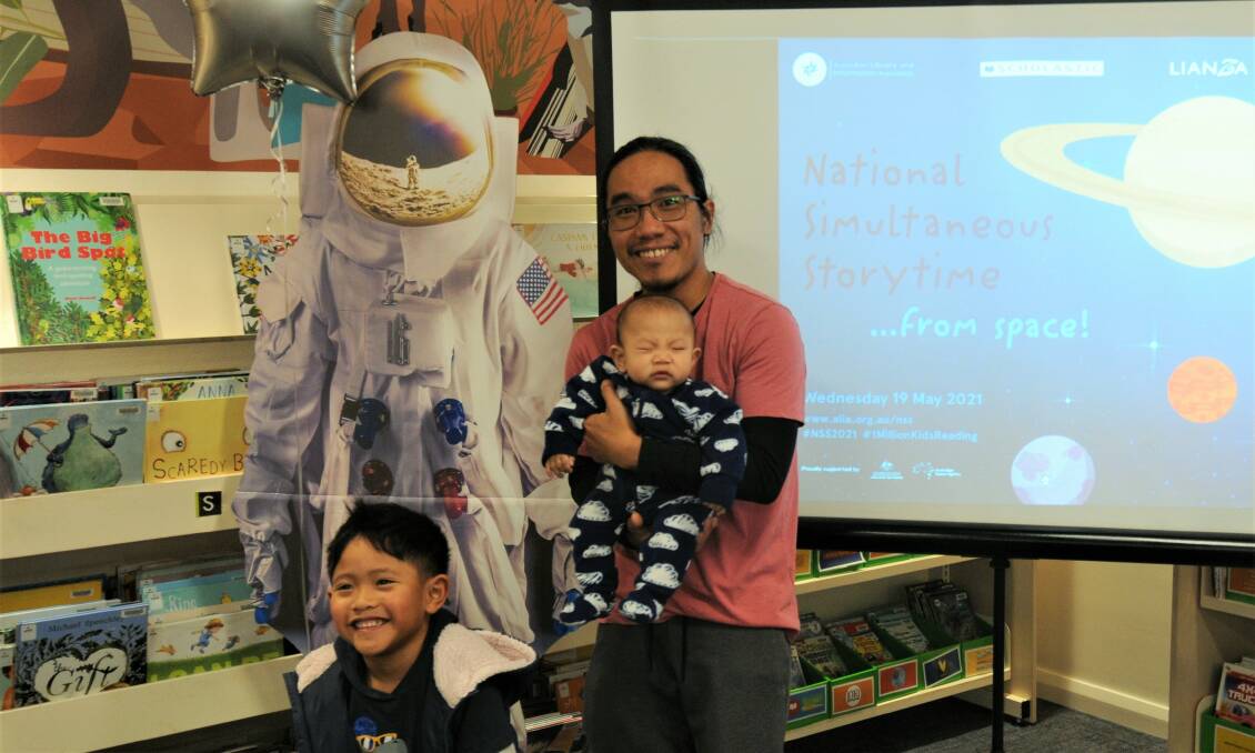STORY TIME: Peter Bolotaolo with sons Matthew and Sebastian at Macquarie Regiondal Library Dubbo. Photo: TAYLOR DODGE. 