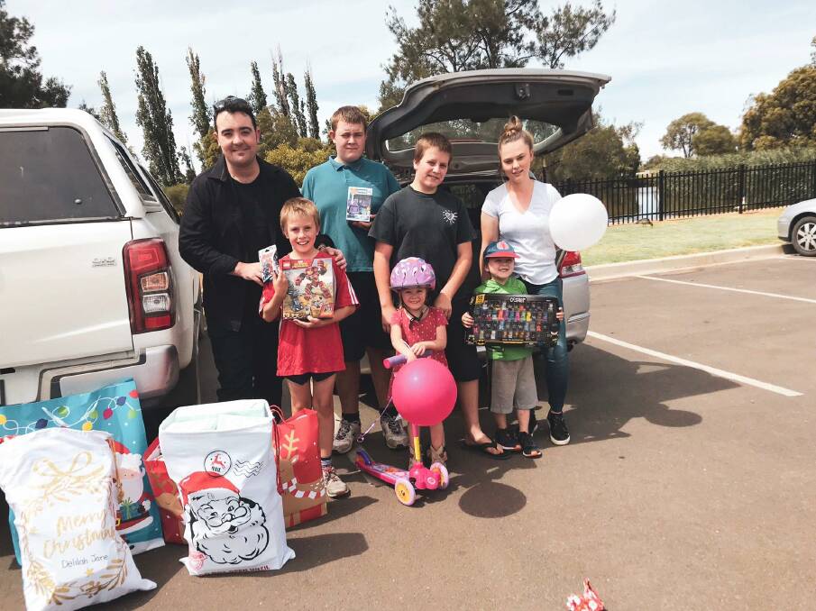 CHRISTMAS GIVING: Jason Owen with Eli and his family in Tottenham NSW Central West. Photo: SUPPLIED. 