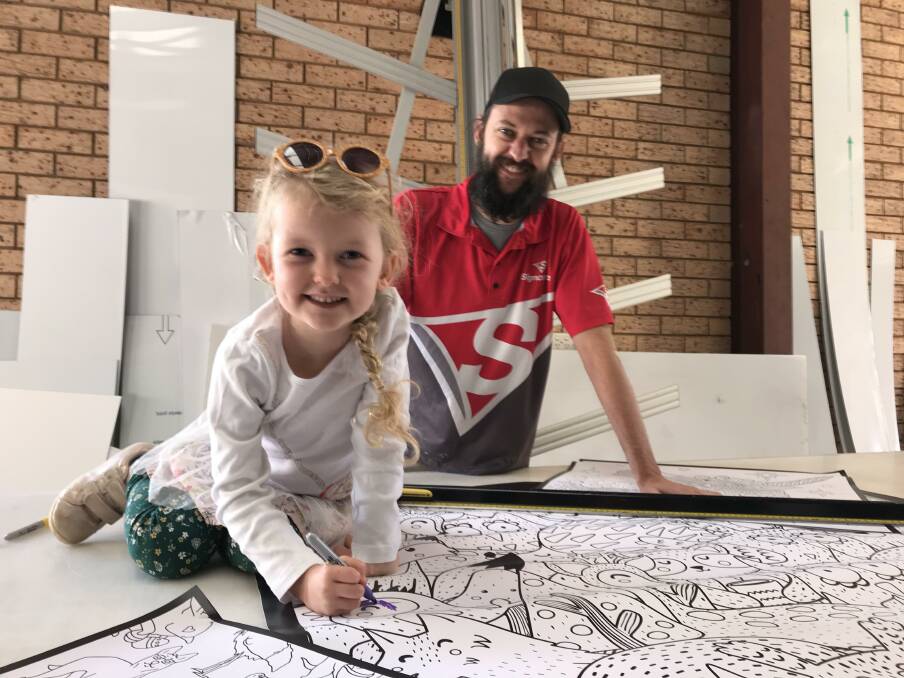 BONDING TIME: Luke Lyons and his daughter enjoy some colouring in on Tuesday afternoon. Photo: CONTRIBUTED. 