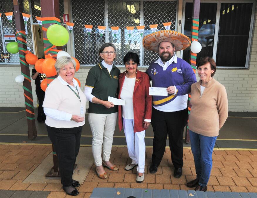 FIESTA CELEBRATES FUNDRAISER: Can Assists Fitz Mckay and Prue Thompson with St Pius' principal Heather Irwin, Relay for Life's Jason Dreamer and Melva Blake. Photo: TAYLOR DODGE.