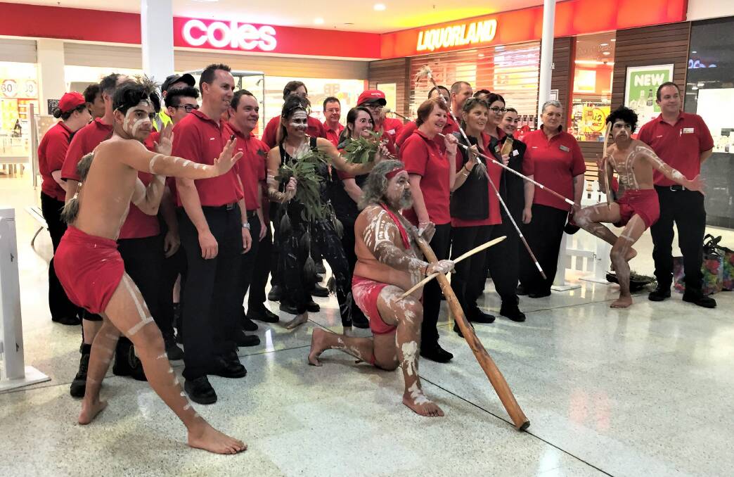 OPEN: Dubbo Coles staff celebrate the opening of their new-look supermarket with a traditional smoking ceremony. Photo: TAYLOR DODGE.