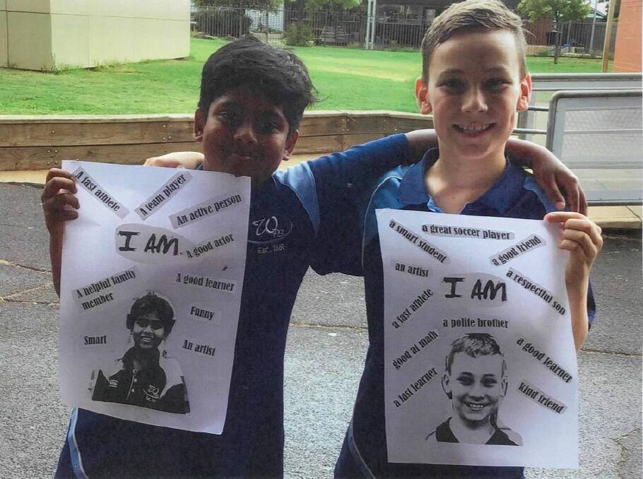 THE WAY TO WELLNESS: Wellington Public School students Sanjit and Logan with their self esteem activity. Photo: CONTRIBUTED. 