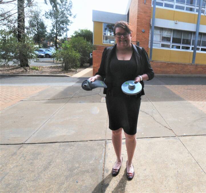 PHONE BAN ADVOCATE: Dubbo College South Campus principal Linda Macleod showcases the lockable pouches and the device used to unlock them. Photo: TAYLOR DODGE. 