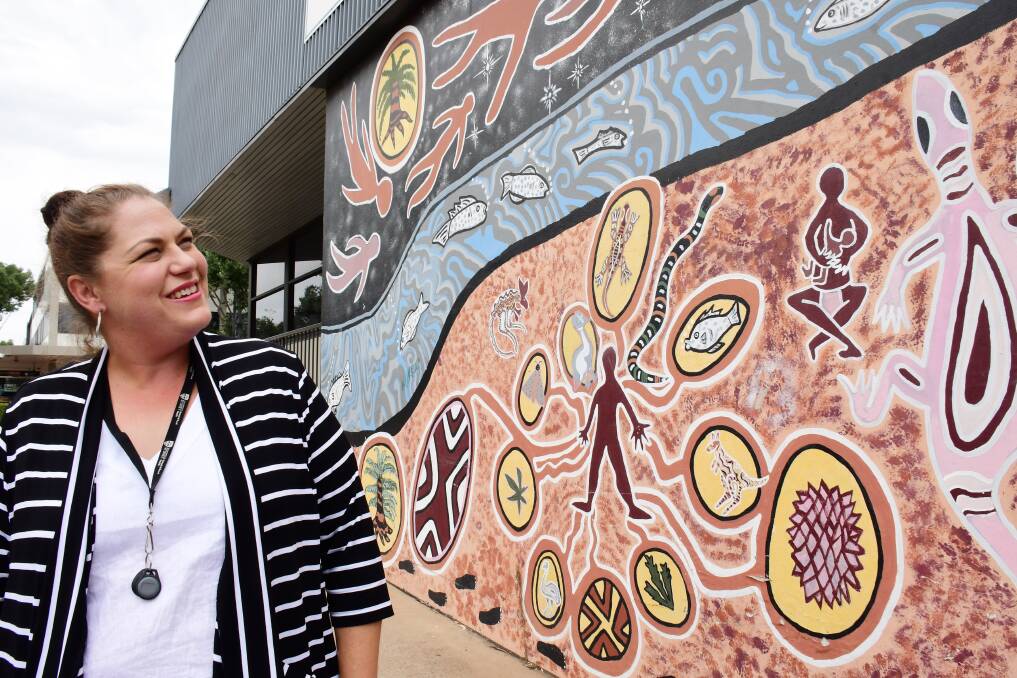 DEADLY ART: Nikki Roberts admires a Wiradjuri mural outside Dubbo's Macquarie Regional Library. Photo: BELINDA SOOLE.