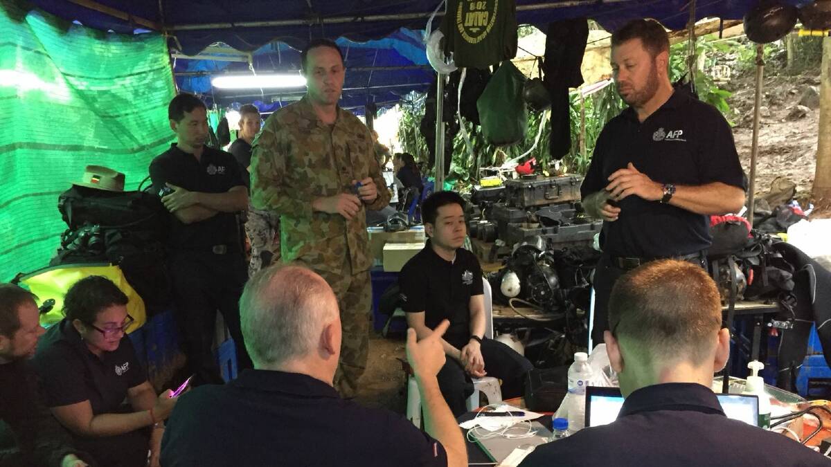Major Rubin translates orders from the Thai rescue commander during a Team Australia brief.