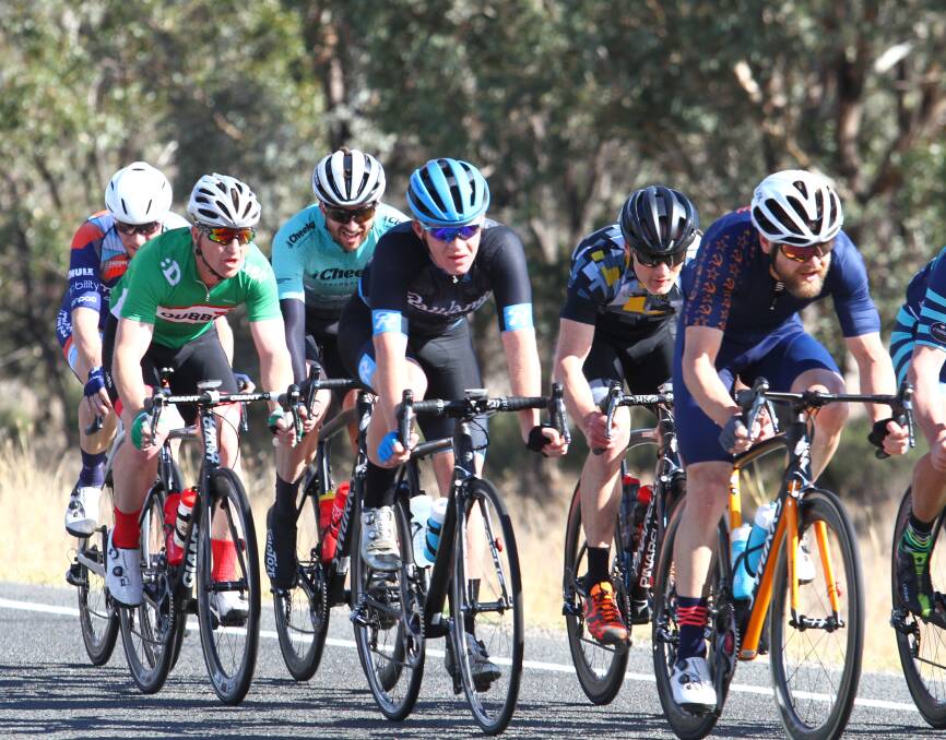 TESTING: Eather (blue helmet) deals with a strong crosswind about 30 kilometres from the finish line. Photo: MARK BODE