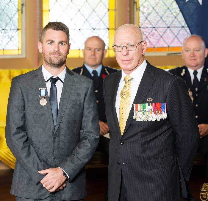 HONOUR: Yeoval crash hero Travis Boland with the NSW Governor His Excellency General The Honourable David Hurley AC DSC (Ret’d). Photo: CONTRIBUTED