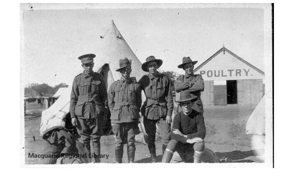 'We arrive at Dubbo': A group of soldiers in front of a tent and the poultry pavilion at the Dubbo Army Camp, 1916. Picture by Macquarie Regional Library