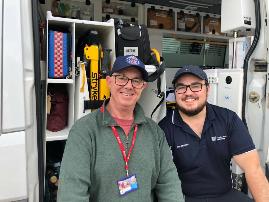 INSPIRED Second year paramedicine student at Charles Sturt University, Tom Parker (right) grew up inspired by his paramedic father Adam Parker (left). Photo: CONTRIBUTED