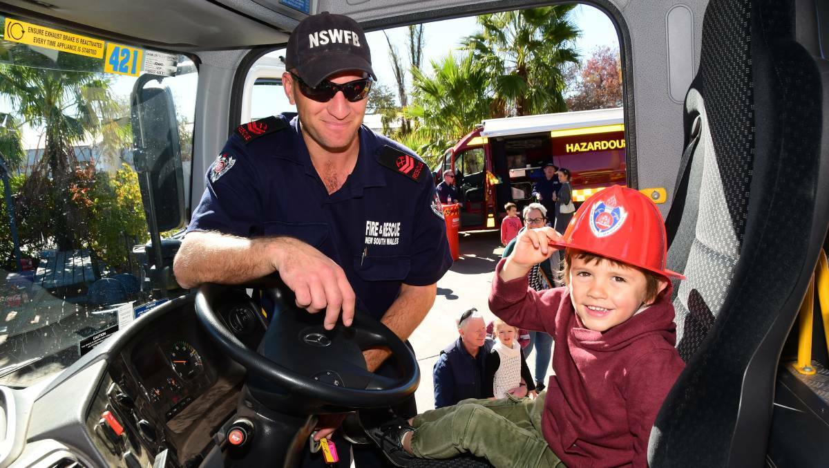 STARTING EARLY: Firefighter Dominic Zumbo shows Hudson McConnell the fire engine during the open day. Photo: AMY MCINTYRE