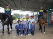 Students from Buninyong Public School with senior constables Barry Turnbull, Warwick O'Reilly, Hero and Prince. Picture: Belinda Soole