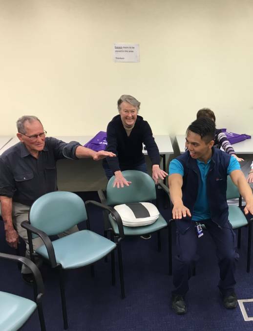 GETTING PHYSICAL: Physio Joshua Onden Lim works with Peter Giddy and Gai Lister on staying healthy and active. Photo: GRACE RYAN.