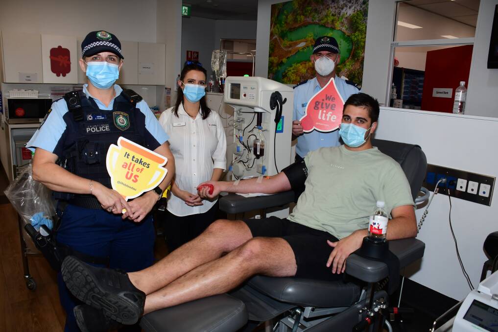 BLOOD BLITZ: Sergeant Jan Colbran, Zoe Foote, senior constable Marty Paice with Henry Blomfield who was donating blood on Friday. Photo: AMY McINTYRE