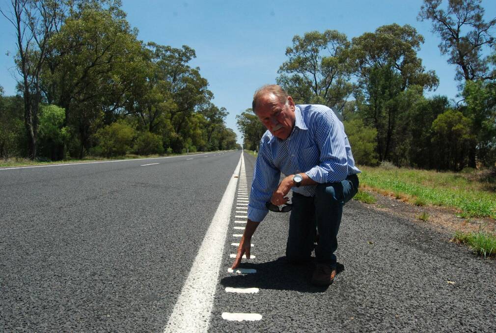 SAFETY: Narromine mayor Craig Davies with the audio tactile line marking installed on the highway west of Trangie. Photo: JEN HOAR