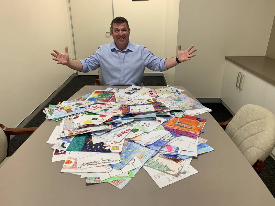 GET DRAWING: Member for the Dubbo electorate Dugald Saunders picking the winners of his 2019 Christmas card competition. Photo: CONTRIBUTED