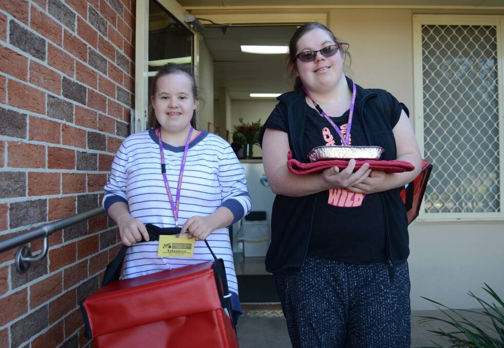 VOLUNTEERS: Emily Gardner and Anna Gibson get ready to deliver meals around Dubbo on Thursday morning. Photo: ELOUISE HAWKEY