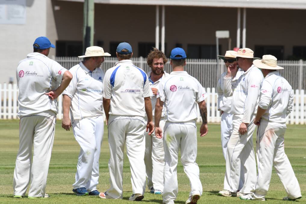 Well done: Joe Haylock surrounded by his teammates after taking one of his four wickets. Photo: BELINDA SOOLE. 