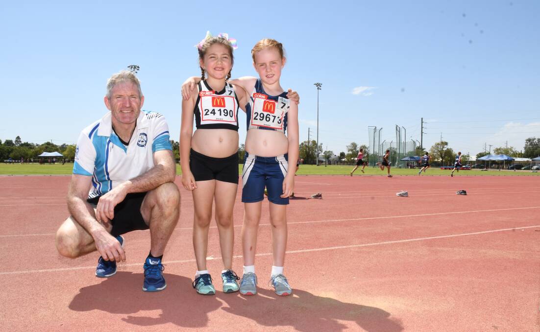 Older and Young: The second oldest athlete at the New Year Carnival, Cameron Porteous, with the youngest, Madison-Leigh Wardman and Emily O’Connell. Photos: AMY MCINTYRE.