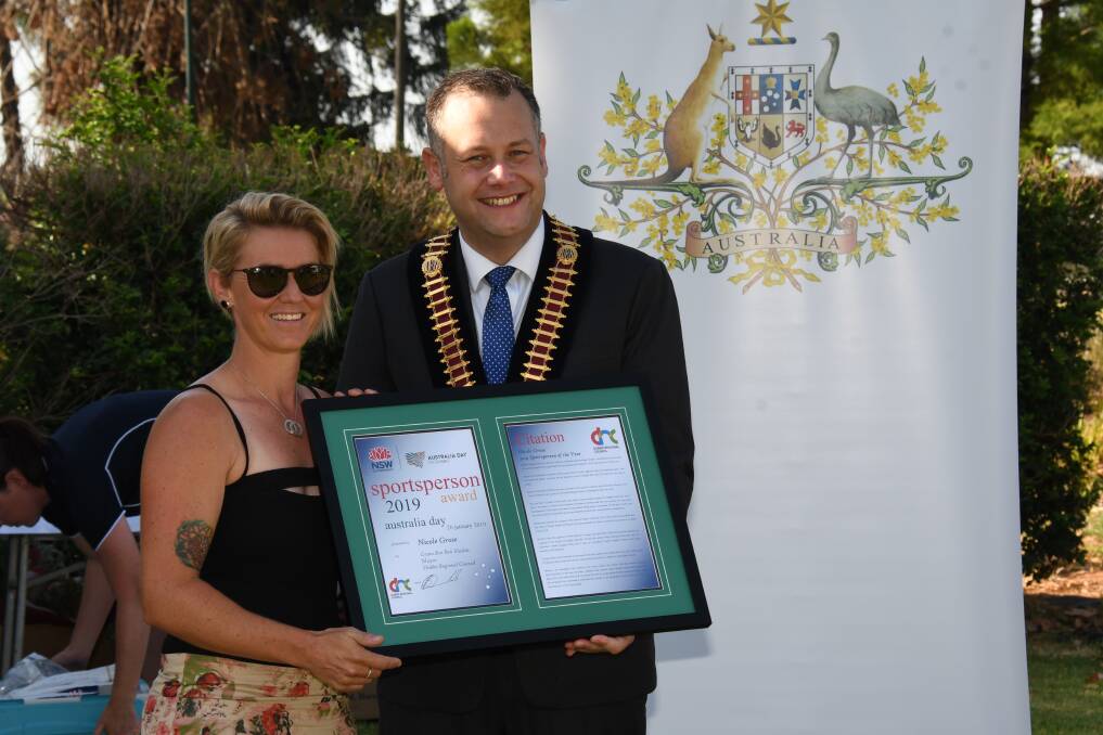 A touching reward: Dubbo’s 2019 Sportsperson of the Year Nicole Grose receives her award from mayor Ben Shields. Photo: AMY MCINTYRE.
