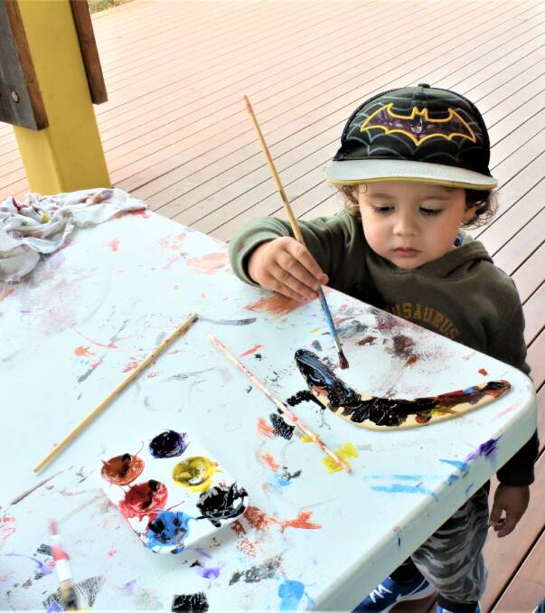 Dubbo's Sam Naden painted his boomerang during NAIDOC week celebrations. 