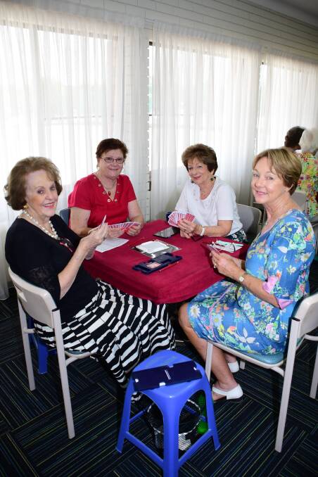 I'll raise you: Gwen Crampton, Penny Meers, Jocelyn Jaques and Janet Ruskin-Rowe look to score a preemptive bid during a bridge game that raised money for Can Assist. PHOTO: AMY MCINTYRE.