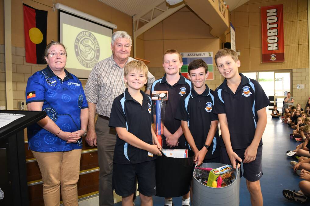 Kim Colbourne and Ian Wray from Vinnies, with Fletcher Horsburgh, Xavier Brown, Aidan Doherty and Rusty Simmonds from St Laurence's Catholic Primary School. Picture by Amy Mcintyre