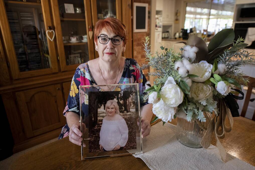 Ann Beggs, photographed in 2022, holding a photograph of her daughter Carrie-Ann Beggs who died from melanoma aged 43. Picture by Belinda Soole