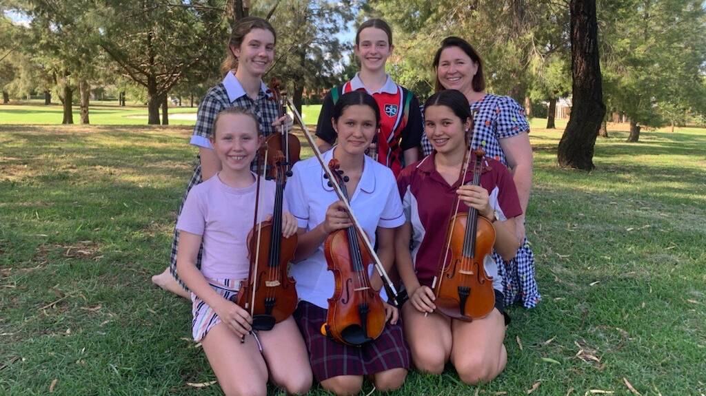 Dubbo members of the Overture Youth Orchestra (back) Alexis Pfeiffer, Miranda Pfeiffer, Conductor Alison Williams, (front) Ruby Williams, Adele Bishop and Elke Bishop. Picture supplied