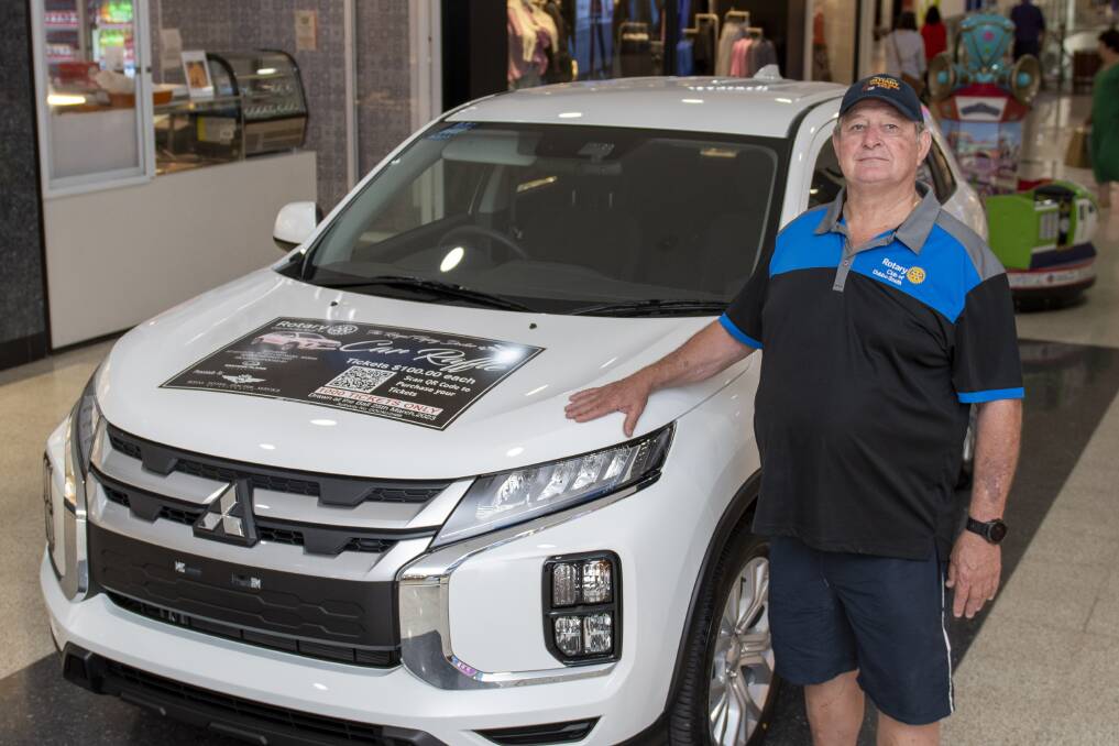 Rotary Club of Dubbo South member David Lomax showing the brand-new Mitsubishi model valued at $35,000 donated by Western Plains Mitsubishi which was raffled to raise funds for the Royal Flying Doctor Service. Picture by Belinda Soole